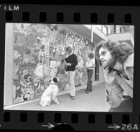 Art therapist Don Dollinger, watching two people paint mural at Beverlywood, an after care center in Los Angeles, Calif., 1974