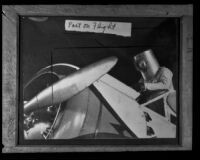 Wearing his special flying suit and helmet Wiley Post climbs into the Winnie Mae, Los Angeles County, circa 1935