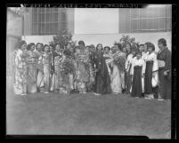 Akiko Tsukimoto, arriving with "Friendship Flame" from Japan meeting priest H. Araki in Los Angeles, Calif., 1939