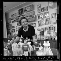 Ruth Handler, executive of Mattel Toy company, posing with collection of Barbie dolls, 1961