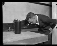 Dr. Russell M. Otis peering into an electroscope, Pasadena, 1924