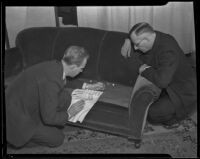 Police forensic chemist Ray Pinker and Detective Miles Ledbetter examine evidence in the murder of Celia Holmes, Los Angeles, 1935