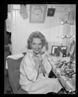 Actress Judy Holliday clutching telegram in her dressing room before opening of the 22nd season of the Los Angeles Civic Light Opera