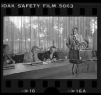 Mayor Tom Bradley watching William Robertson and Oakland Raiders' partner Al Davis signing memorandum moving Raiders team to Los Angeles, Calif., 1980