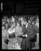 Lawrence Welk signing autographs during his appearance at the Hollywood Palladium in Hollywood, Calif., 1961