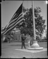 Edward E. Spence and Norman A. Pabst fly the flag at half mast at City Hall upon news of the death of Will Rogers, Beverly Hills, 1935