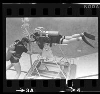 Dr. Glen H. Egstrom conducting underwater test with scuba diver in Los Angeles, Calif., 1966