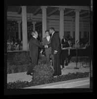 Bing Crosby greeting two men at a fundraiser at the Getty Villa, Los Angeles, 1975