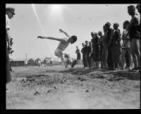 Sailor Flynn broad jumps during the Pacific Fleet's track championship meet, Long Beach, 1922