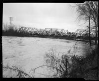 Center Street bridge spanning the San Gabriel River swollen with rainstorm flooding, Los Angeles County, 1927