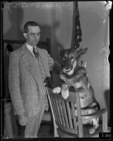 Judge Charles B. MacCoy stands with police dog Peter the Great Jr., Los Angeles, 1934