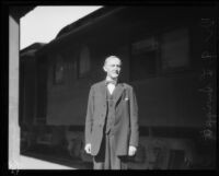 Educator Glen L. Swiggett near train, [1925?]