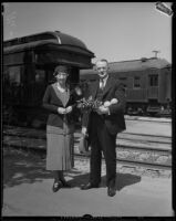 Mr. L. A. Downs, president of the Illinois Central Railroad, and his wife at a railroad station, 1926-1938