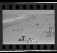 Sunbathers during overcast day at Newport Beach, Calif., 1966