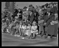 Children with curb-front seats on the route of the Tournament of Roses Parade, Pasadena, 1932