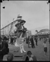 Woman with camera at amusement park, Long Beach, [1930s]