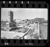 Construction of houses with ruins of house destroyed in wildfire in Baldwin Hills, Calif., 1986