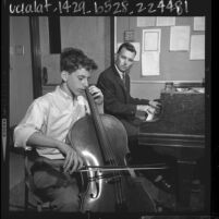 Fourteen year old Avner Ash playing cello with teacher, Peter Schartz, 1964