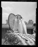 Florine Gonsalves crowns Our Lady of Fatima statue during Portuguese festival in Artesia, Calif., 1948