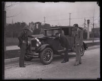 Stunt driver Hayward Thompson and his manager W. H. Watson inspecting his Pontiac Six, Los Angeles, 1927