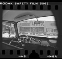 View from inside car of Mel's Sporting Goods where robbery involving Patty Hearst took place, Inglewood, Calif., 1976