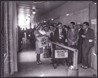 Woman selling ice cream to the crowd in courthouse hallway at David H. Clark's murder trial, Los Angeles, 1931