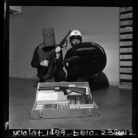 Two Los Angeles police officers modeling anti-riot defense gear, 1967