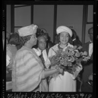 Coretta Scott King receiving flowers upon arrival at Los Angeles airport, 1965