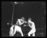 Cisco Andrade, left, punches Art Aragon, 1956