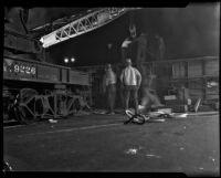 Workmen move overturned streetcar on Pico and Vermont, Los Angeles, 1934