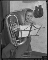 Boxer Wally Hall playing his tuba, Los Angeles, 1936