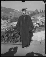 University of California president Robert G. Sproul, in cap and gown, at UCLA graduation ceremony at Hollywood Bowl, Los Angeles, [1932?]