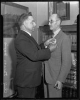 Chief James Davis pins a badge to William Adolph, Los Angeles, 1935