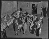 Little children receive gifts from Santa Claus, Los Angeles, 1935