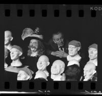 Walt Disney with unfinished plastic heads of pirates for the "Pirates of the Caribbean" ride, Anaheim, 1966