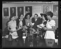 Powder Puff Derby pilots receiving scrolls from Varian Green in Miami, Fla., 1949