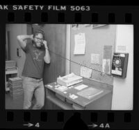 Caltech molecular biology fellow Richard Scheller, talking on phone in hallway at Caltech in Pasadena, Calif., 1980