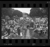 Demonstrators with signs reading "No Pasaran" and "Stop Bombing El Salvador" in front of Los Angeles City Hall, 1986