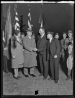 Ralph T. O'Neil shakes hands with an unidentified man, accompanied by wife Margaret O'Neil and John R. Quinn, Los Angeles, circa 1931