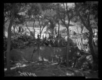 Police and FBI officers search the ruins of Fountain of the World headquarters for bodies and evidence, 1958