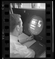 Man working at computer with round monitor screen, 1965 — Calisphere