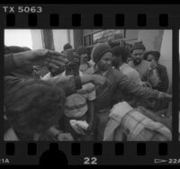 Homeless people receiving food hand-outs outside of Los Angeles County Board of Supervisors meeting, Calif., 1986