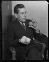 Ben Gorchakoff shows off tennis balls, Los Angeles, 1928