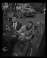 Bishop Asaiah talks with police and reporters outside the ruins of the headquarters of the Fountain of the World religious collective. A. 1958