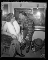 Comedians Broderick Crawford in drag with George Burns backstage during Friars Frolics in Los Angeles, Calif., 1950