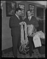 Captain Clem Peoples, county jailer, and unidentified man hold a long rope, Los Angeles, 1933