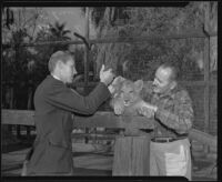 Robert D. Loken and Charles Gay at Gay's Lion Farm, El Monte, 1940