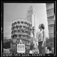 Three city employees with display of trash cans during Los Angeles, Calif. National Public Works Week in 1964