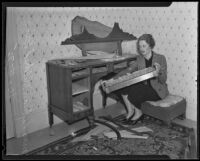 Lillian Mildred Rice holds up a piece of broken furniture, Los Angeles, 1935