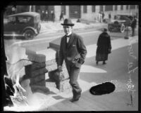 Distric Attorney Thomas Lee Woolwine walks up steps, Los Angeles, 1920-1923